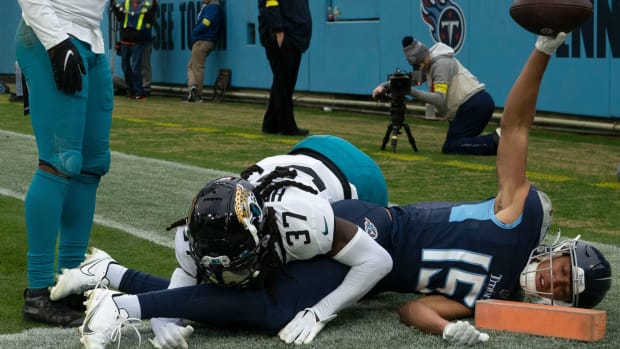 Tennessee Titans wide receiver Nick Westbrook-Ikhine (15) celebrates his touchdown catch over Jacksonville Jaguars cornerback Tre Herndon (37) during the fourth quarter at Nissan Stadium Sunday, Dec. 11, 2022, in Nashville, Tenn.